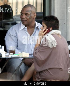 Mike Tyson lunches with two female friends at Joans On Third. Tyson is reportedly in talks for a potential third boxing rematch with Evander Holyfield. Tyson was disqualified during their last bout in 1997 when Tyson  took a bite out Holyfield's ear. Los Angeles, Ca. 3/5/08. Stock Photo