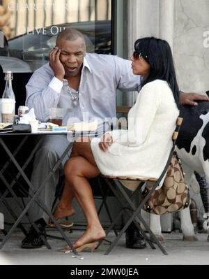 Mike Tyson lunches with two female friends at Joans On Third. Tyson is reportedly in talks for a potential third boxing rematch with Evander Holyfield. Tyson was disqualified during their last bout in 1997 when Tyson  took a bite out Holyfield's ear. Los Angeles, Ca. 3/5/08. Stock Photo