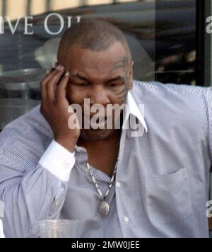 Mike Tyson lunches with two female friends at Joans On Third. Tyson is reportedly in talks for a potential third boxing rematch with Evander Holyfield. Tyson was disqualified during their last bout in 1997 when Tyson  took a bite out Holyfield's ear. Los Angeles, Ca. 3/5/08. Stock Photo