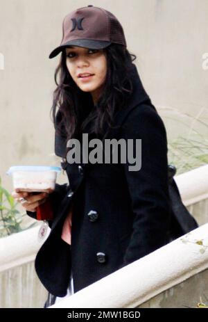 EXCLUSIVE!! Actress Vanessa Hudgens dresses down in sweatpants, Ugg boots and a baseball cap for her trip to LAX to catch a flight out of town.  Hudgens, who reportedly met up with ex-boyfriend Zac Efron last night at Eden nightclub, carried a reusable container of food and seemed to have eaten it in the car as she didn't carry it once at the airport.  Los Angeles, CA. 01/08/11. Stock Photo
