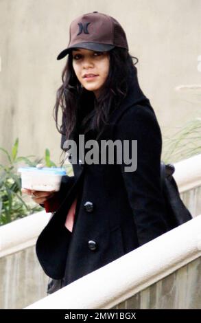 EXCLUSIVE!! Actress Vanessa Hudgens dresses down in sweatpants, Ugg boots and a baseball cap for her trip to LAX to catch a flight out of town.  Hudgens, who reportedly met up with ex-boyfriend Zac Efron last night at Eden nightclub, carried a reusable container of food and seemed to have eaten it in the car as she didn't carry it once at the airport.  Los Angeles, CA. 01/08/11. Stock Photo