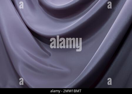 The texture of a luxurious smooth fabric in blue, purple with folds and waves. Blue fabric, material Stock Photo