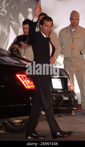 Actor Matthew McConaughey, who presented an award, arrives with his girlfriend and mother of his two children Camila Alves at the Vanity Fair Oscars after-party held at Sunset Tower Hotel following the 83rd Annual Academy Awards.  Matthew took a moment to look at Camila's dress, which was different from the one she walked down the red carpet in.  Los Angeles, CA. 02/27/11. Stock Photo