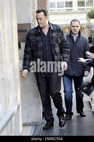 New father Vince Vaughn signs autographs for fans as he arrives and later leaves the studios of BBC Radio where he promoted his new movie 'The Dilemma', co-starring Jennifer Connelly and Winona Ryder.  Vaughn, whose daughter Locklyn Kyla Vaughn turned one month old yesterday, appeared happy to greet his fans despite looking a little tired.  Winona Ryder has said of Vaughn, 'I describe Vince as this volcano of energy and great ideas and so generous. He will come up with a great line and he will be like, 'Hey you should say that.'Ê It was such fun working with him, most of my scenes were with hi Stock Photo