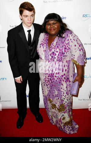 Gabriel Basso and Gabourey Sidibe pose for photographers at The Weinstein Company and Relativity Media's 2011 Golden Globe After Party following the 68th Annual Golden Globe Awards held at The Beverly Hilton hotel. Los Angeles, CA. 01/16/11. Stock Photo