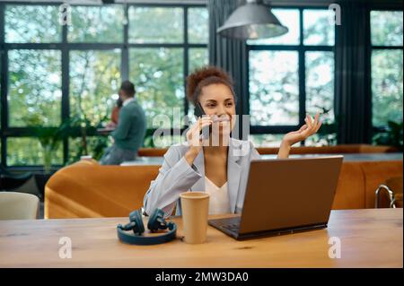 Young woman freelancer working at coworking space Stock Photo