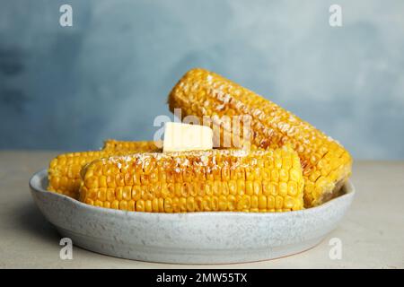 Delicious grilled corn with butter on table Stock Photo