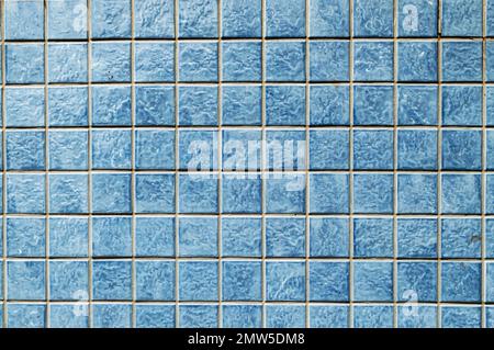 Beautiful wall of small colorful square blue tiles. Stock Photo