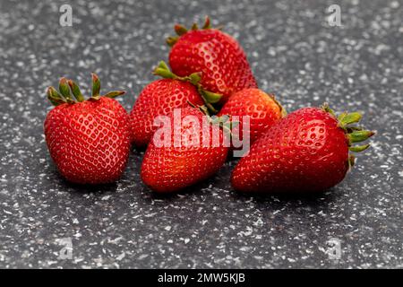 Fresh ripe strawberries on counter. Organic fruit, healthy diet and nutrition concept. Stock Photo