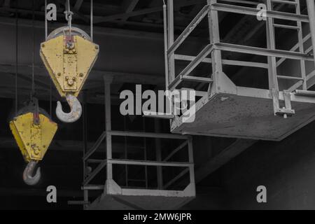 Two steel hooks of an old crane system in a disused coal mine Stock Photo