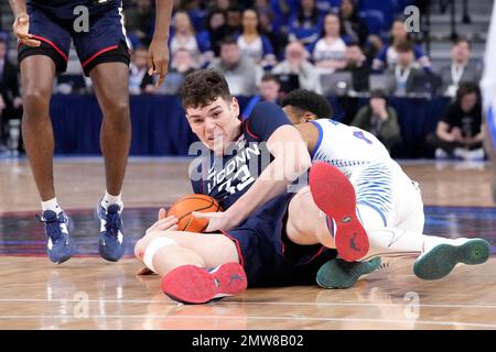 Connecticut's Donovan Clingan wrestles for a loose ball with DePaul's K ...