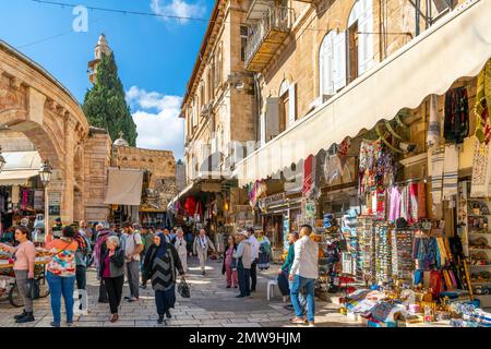 Tourists walk in a crowded alley of shops and markets in the medieval Old City of Jerusalem, Israel. Stock Photo