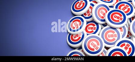 Logos of the American Major League Baseball Team Chicago Cubs on a heap on a table. Stock Photo