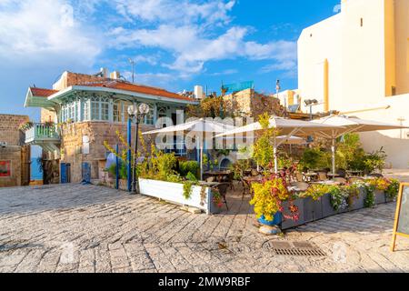 A colorful cafe with outdoor seating in Kedumim Square (Kikar Kdumim), in the medieval Ottoman era old town of Jaffa, Israel. Stock Photo