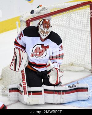 New Jersey Devils goaltender Martin Brodeur, right, pokes the puck