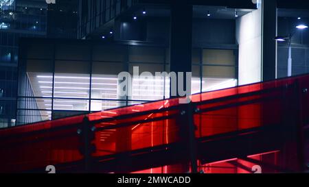 Skyscraper lobby in  business district. Big glass windows in commercial skyscraper at night. Stock Photo