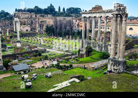 View of ruins with columns of Temple of Saturn, left in the background Basilica Julia Basilica Iulia, on the horizon Palatine Hill, Roman Forum Stock Photo