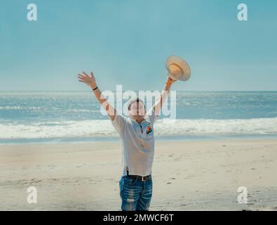 Happy handsome man on vacation outdoors, Happy latin young man on the beach, Tourist travel Stock Photo