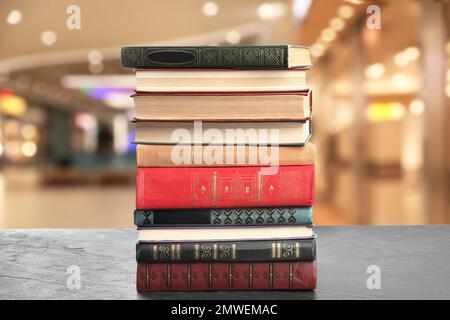 Collection of different books on table against blurred background Stock Photo