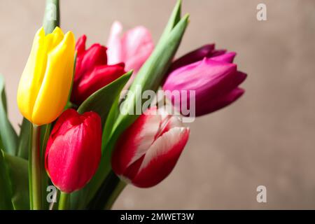 Beautiful spring tulips on light pink background, flat lay. Space for ...