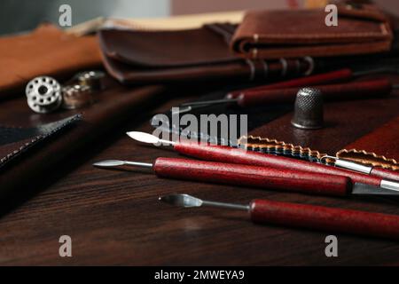 Leather samples and tools on wooden table Stock Photo