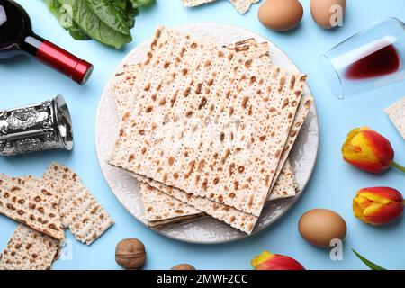 Flat lay composition with symbolic Pesach (Passover Seder) items on light blue background Stock Photo