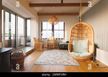 General view of luxury living room interior with armchairs, sofa and hanging basket chair Stock Photo