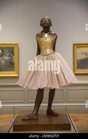 'The Little Fourteen Year-Old Dancer,' 1922(cast), 2018 (tutu). by Edgar Degas, partially tinted bronze, cotton, silk, satin and wood. Metropolitan Museum of Art, New York City. Stock Photo