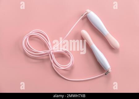 Fitness and healthy sport concept. Pink jumping rope on a pastel pink background. Stock Photo