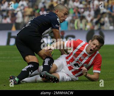 Dario Veron, left, of Pumas, fights to head the ball against Guillermo  Franco of Monterrey during the first game of the Mexican soccer championship  final at the University Stadium in Mexico City