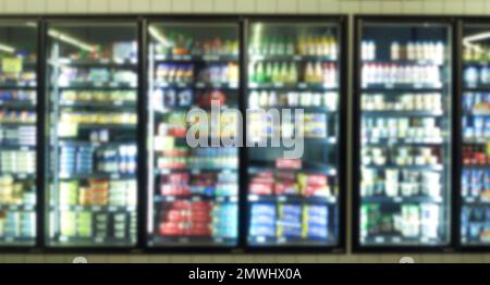 Abstract blur background of freezer shelf fill with variety if soft drinks in a supermarket. Stock Photo