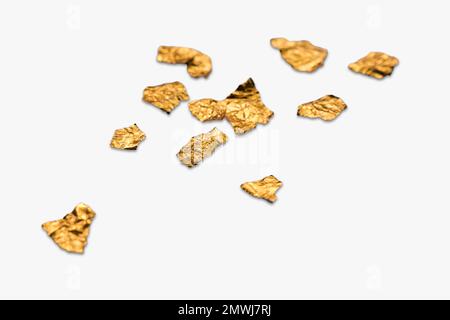 Shiny pieces of crumpled and creased gold foil or leaf isolated on a white background. Stock Photo