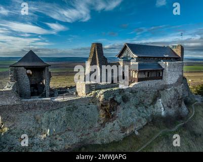 Aerial view of partially restored Boldogko, medieval Gothic castle in Borsod county Hungary with round gate tower, donjon cloudy blue sky background Stock Photo