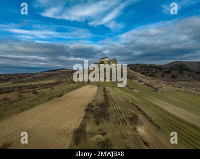 Aerial view of partially restored Boldogko, medieval Gothic castle in Borsod county Hungary with round gate tower, donjon cloudy blue sky background Stock Photo