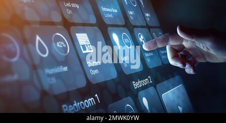 Person touching a button on smart home dashboard interface to control connected devices and set up automation technology. Using smart assistant to use Stock Photo