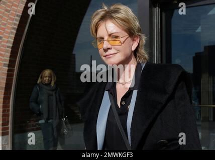 FILE - In a Thursday, Feb. 7, 2013 file photo, author Patricia Cornwell leaves federal court in Boston, after she took the stand in her lawsuit against her former financial management company. Cornwell settled a lawsuit Tuesday, Jan. 17, 2017, against her former business managers, avoiding a second trial for a case that dates to 2009. The author had claimed the New York accounting firm Anchin, Block & Anchin LLP was negligent in handling her finances and cost her millions in losses or unaccounted for revenue. (AP Photo/Steven Senne, File)