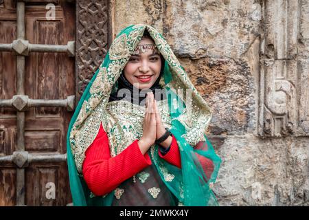 Egyptian girl in traditional dress at El-Moez Street and Khan Khalili Bazaar, Old Cairo, Egypt Stock Photo
