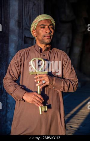 Doorkeeper holding Ankh, the key of life, during sunrise at the Great Sun Temple of Ramesses II at Abu Simbel, Aswan, Egypt Stock Photo