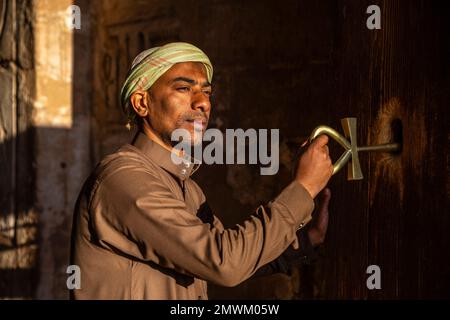 Doorkeeper holding Ankh, the key of life, during sunrise at the Great Sun Temple of Ramesses II at Abu Simbel, Aswan, Egypt Stock Photo