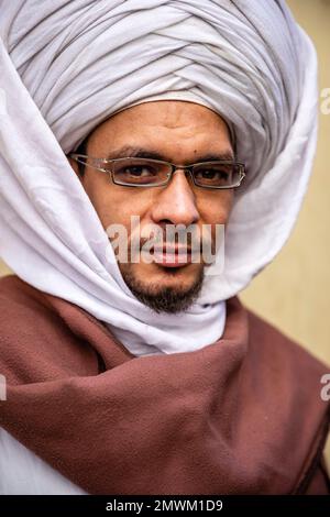 Egyptian man in large keffiyeh in the streets of Luxor, Egypt Stock Photo