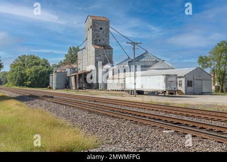 The grain elevator next to the railway trails Stock Photo