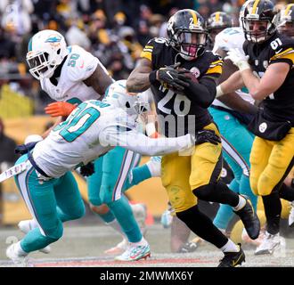 Miami Dolphins free safety Bacarri Rambo (30) brings down Pittsburgh  Steelers running back Le'Veon Bell (26) as Miami Dolphins outside  linebacker Neville Hewitt (46) and Miami Dolphins cornerback Ifo  Ekpre-Olomu (33) closes