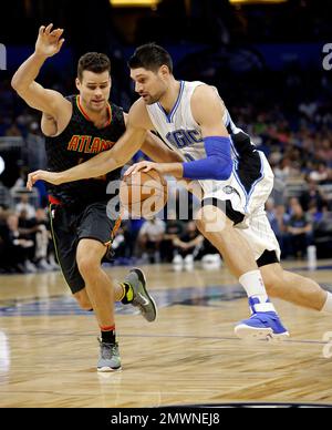 Orlando Magic's Nikola Vucevic (9) drives past Boston Celtics' Daniel Theis  (27) and Semi Ojeleye (37)