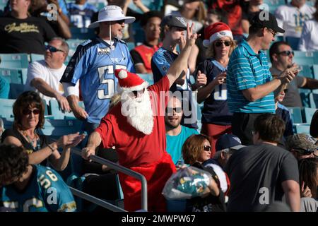 A Tennessee Titans fan is dressed as Santa as he watches the