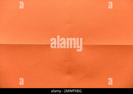 Folded orange paper for background. Stock Photo