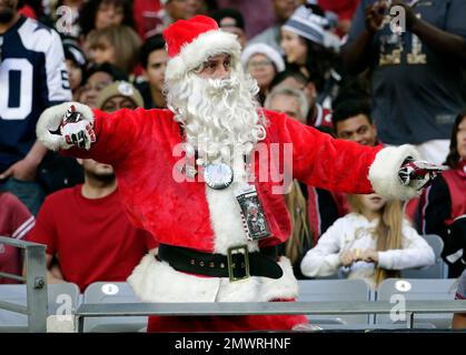 An Arizona Cardinals fan dressed as Santa Claus signals for a safety in the  fourth quarter of the Cardinals-Green Bay Packers game at University of  Phoenix Stadium in Glendale, Arizona, December 27