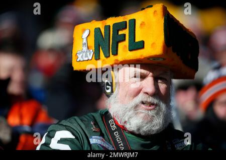 A Green Bay Packers fan wears a cheese hat during the first half