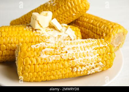 Delicious boiled corn with butter on plate, closeup Stock Photo