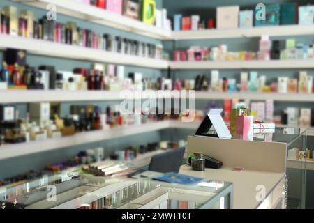 Counter and shelves with perfume bottles in shop Stock Photo