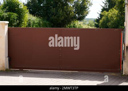 Aluminum portal high brown door access house garden gate Stock Photo